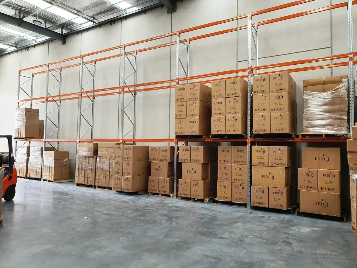 Orange and galvanized pallet racking in a warehouse with boxes stacked