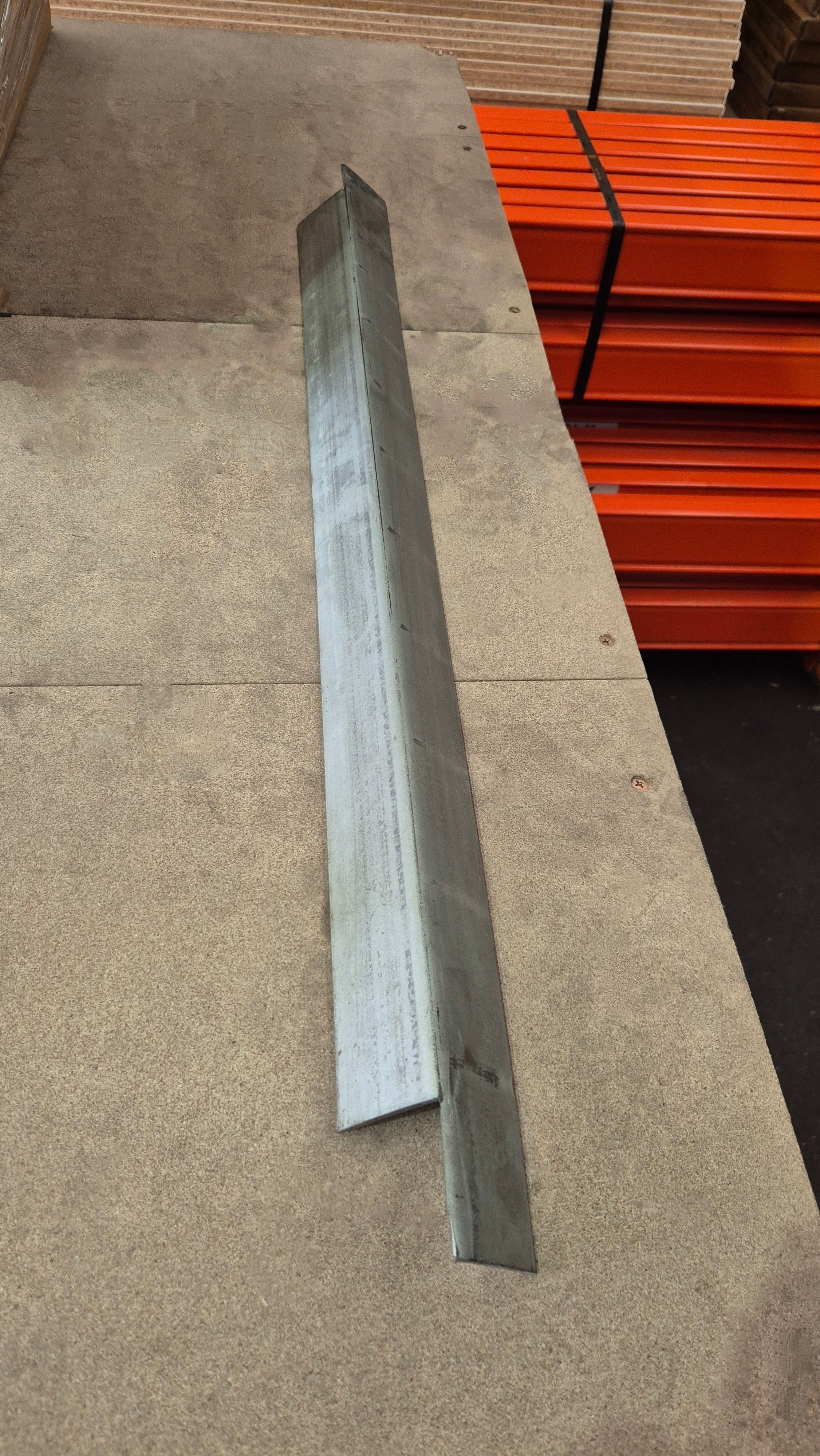 Second hand steel board supports stacked on melamine boards in warehouse, suitable for 840mm deep pallet racking frames